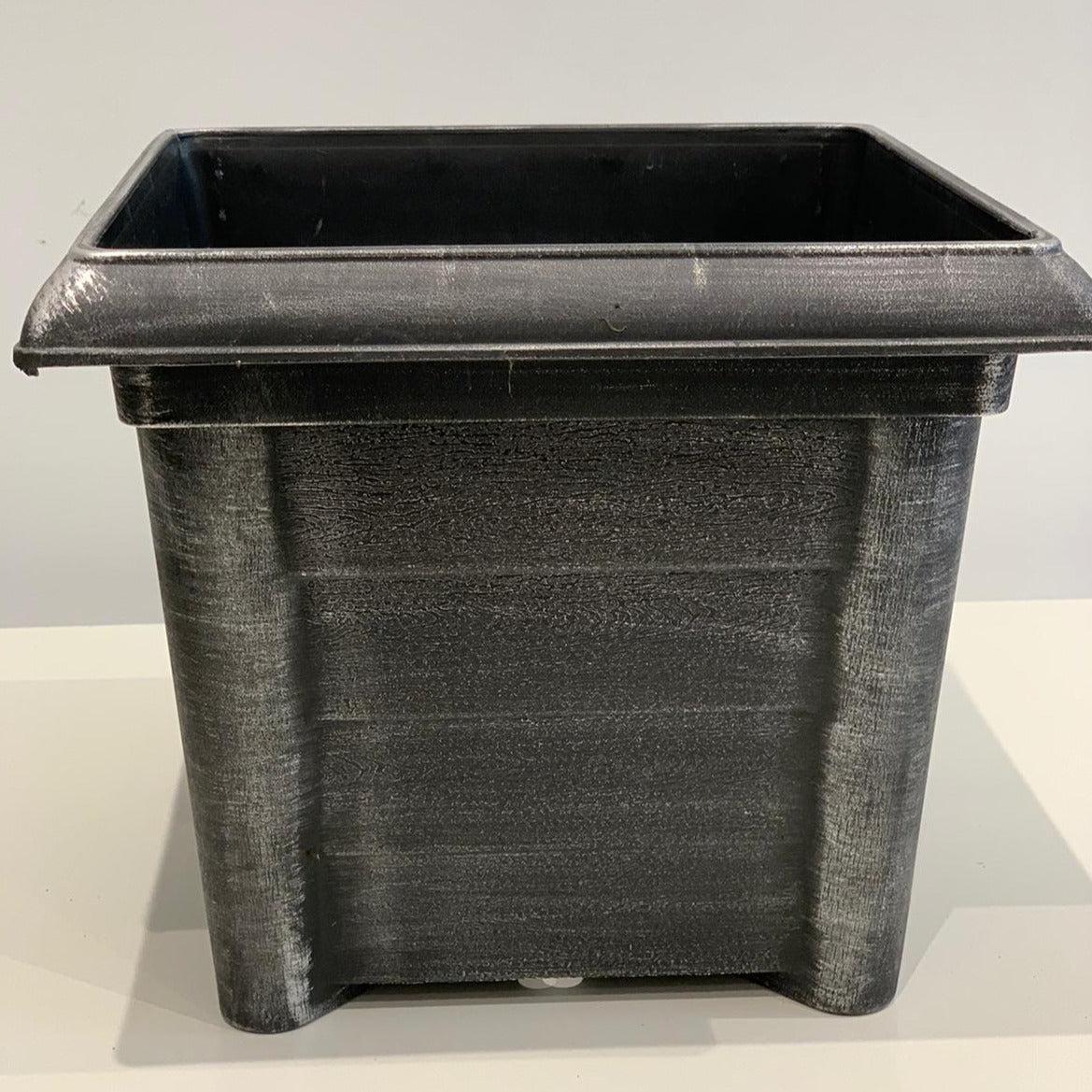 A Silver Square Plastic Pot made of plastic, measuring 22cm high and 26cm wide, is placed on a light-colored surface against a plain background.